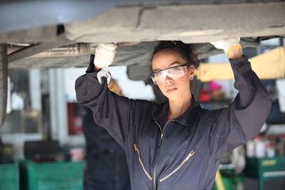 Portrait of female mechanic at garage