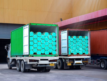 Stuffing bundle of steel pipe in containers on trucks. operation warehous concept.