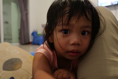 Close-up portrait of cute baby girl at home