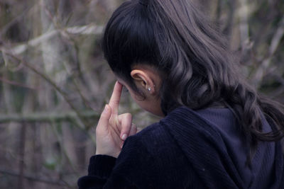 Close-up portrait of woman holding tree