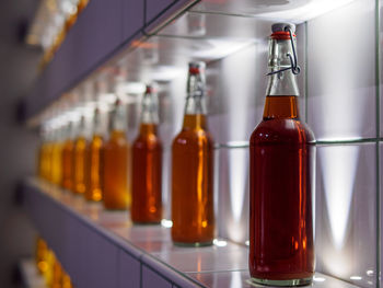 Close-up of alcohol bottles arranged on shelf