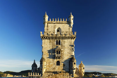 Low angle view of clock tower against clear sky