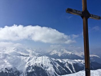 Scenic view of cross against snow covered mountain