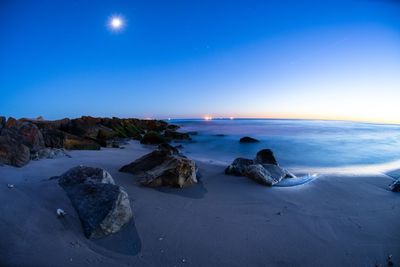 Scenic view of sea against clear blue sky