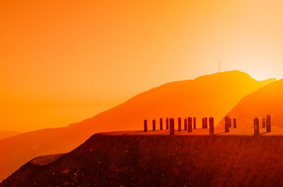 Scenic view of mountains against orange sky