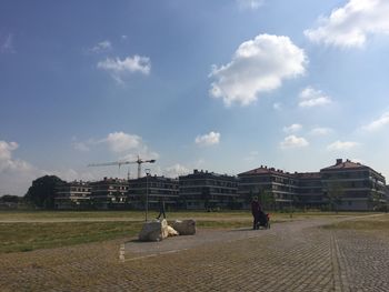 People sitting against sky