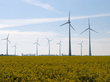 Windmill on field against sky