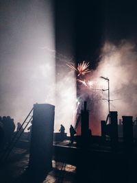 Low angle view of firework display at night