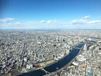 High angle view of cityscape by sea against sky