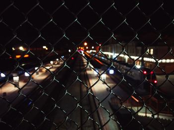 Close-up of chainlink fence at night