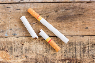 High angle view of cigarette on wooden table