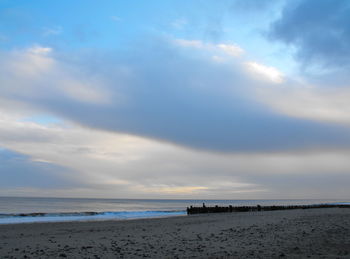 Scenic view of beach against sky during sunset