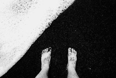 Low section of person standing on tiled floor