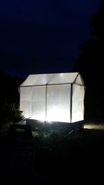 Built structure on field against sky at night