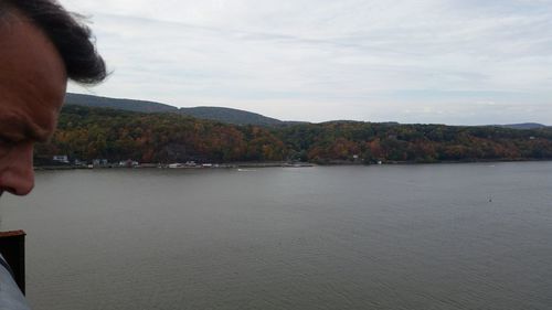 Scenic view of sea and mountains against sky