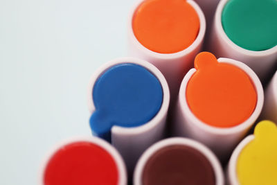 Close-up of multi colored pencils over white background