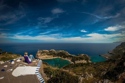 Woman on mountain looking at sea