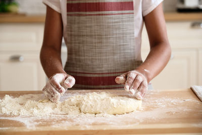 Midsection of person preparing food at home