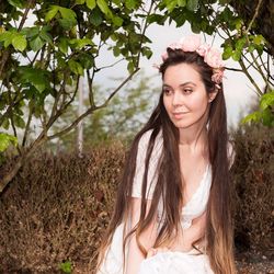 Portrait of smiling beautiful woman against trees