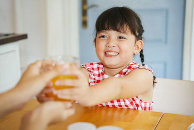 Portrait of happy boy at table at home