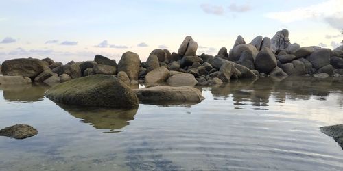 Rocks on shore against sky