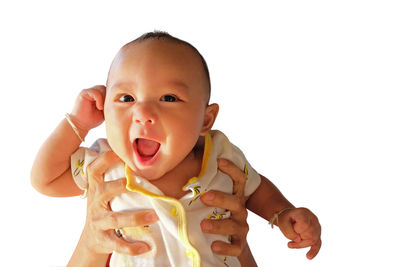 Portrait of cute baby against white background