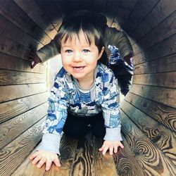 Portrait of baby boy in tunnel slide