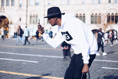 Side view of man walking on street in city