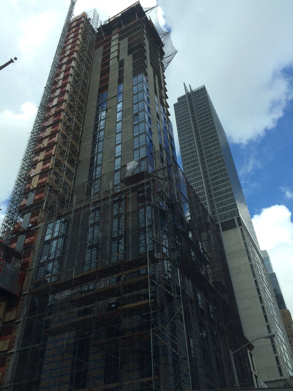 architecture, building exterior, built structure, low angle view, sky, building, city, cloud - sky, modern, tall - high, tower, office building, day, cloud, reflection, outdoors, no people, skyscraper, architectural feature, tilt