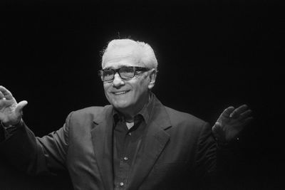 Close-up portrait of man against black background