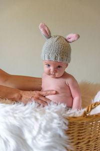 Mother keeping daughter in basket at home