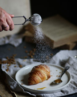 Close-up of person preparing food on table