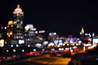 Defocused image of illuminated city at night