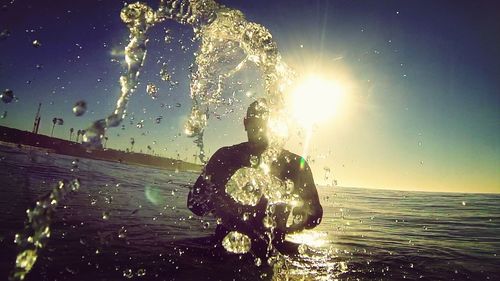 Silhouette of woman in sea