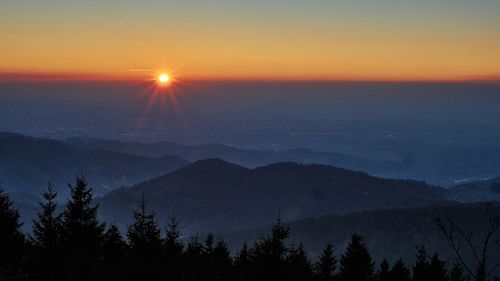 Scenic view of silhouette mountains against sky at sunset