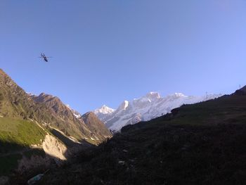 Scenic view of snowcapped mountains against clear blue sky
