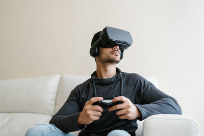 Man using mobile phone on sofa