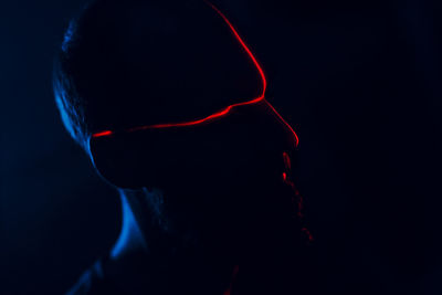 Laser light falling on man in darkroom