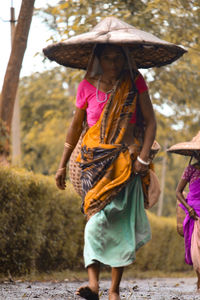 Woman wearing sari walking on road