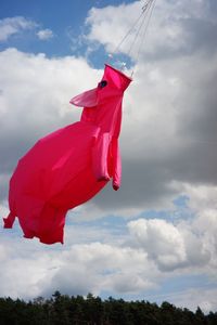 Low angle view of red flags hanging against sky