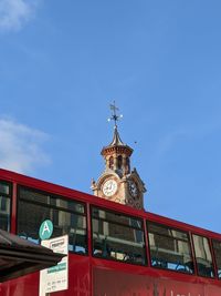 Low angle view of clock tower against blue sky