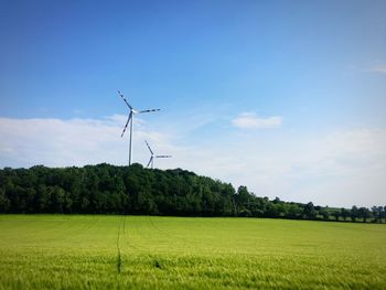 Windmill on field against sky