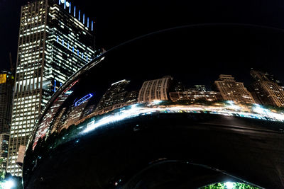 Low angle view of illuminated buildings in city at night