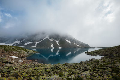 Scenic view of lake and mountains against sky