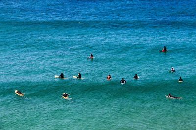 High angle view of people swimming in sea