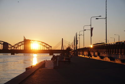 Bridge over river at sunset