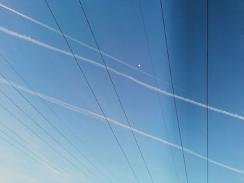 Low angle view of cables against blue sky