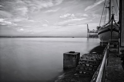 Boat moored in sea against sky