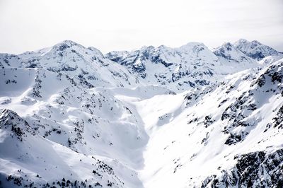 Scenic view of snow covered mountains against sky