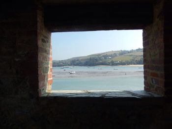 View of sea seen through window